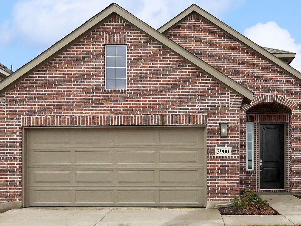 Sophisticated brick facade and elegant arched entrance define this Bel Air Village residence.