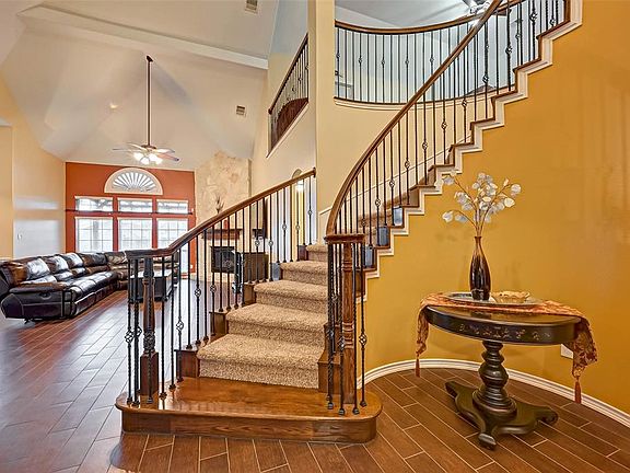 Welcome to this beautiful 5/6 bedroom home. Many upgrades, including the wood look tile all throughout the living and kitchen areas. Gorgeous curved staircase with wood landing will please any buyers.