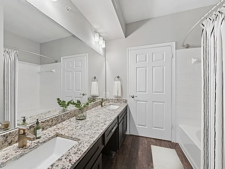 Classic Package II bath with espresso cabinetry, speckled granite countertops, and hard surface flooring
