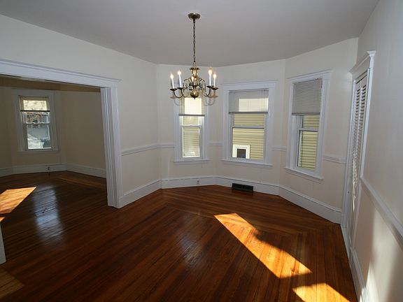 Living room, chandelier, closet bay windows