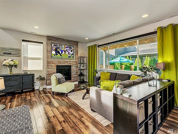 Great room with large fireplace with shiplap added to the surrounding area.