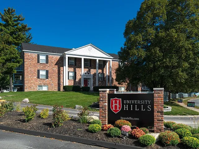 Welcome to University Hills Apartments near the University of Toledo, featuring a beautifully landscaped entrance and classic architecture.