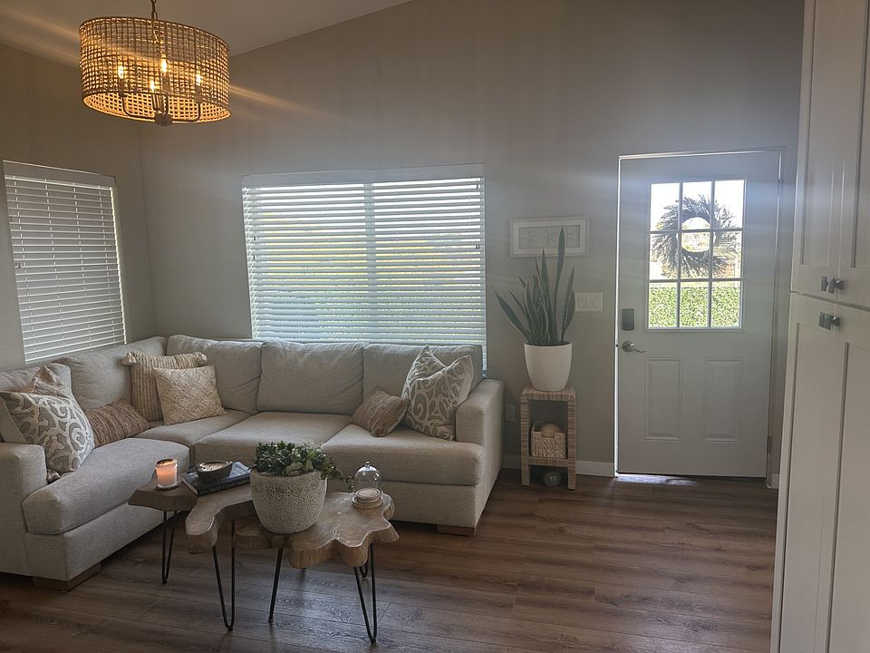 Living Room with luxury vinyl flooring, vaulted ceilings, open to dining and kitchen