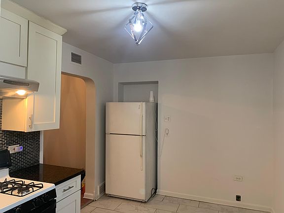 Kitchen/ granite counter with glass backsplash and ceramic tiled floor