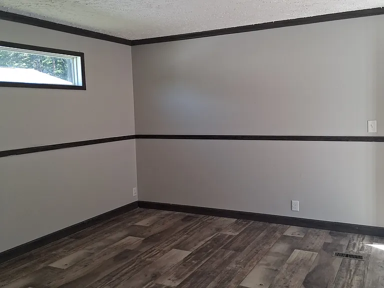 This wide livingroom room will provide space for simply relaxing on the couch to small get togethers.