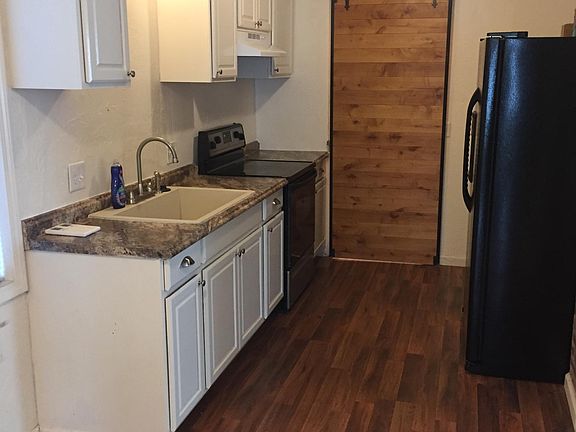 Modern kitchen,frig, stove and barn door