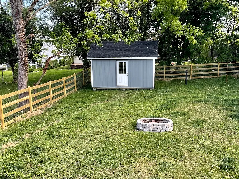 Fenced in backyard with built in ground firepit. Shed not included.