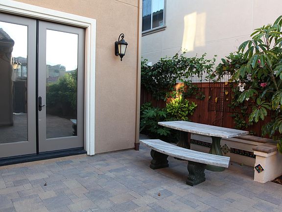 Sitting area in the courtyard. Dinning room open to the tropical courtyard with beautiful tile accent.