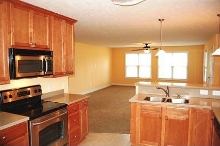 Open Kitchen with Breakfast Bar looing into Family Room