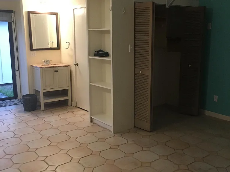 Vanity, shelf, and closet. Italian tile keeps floor cool.