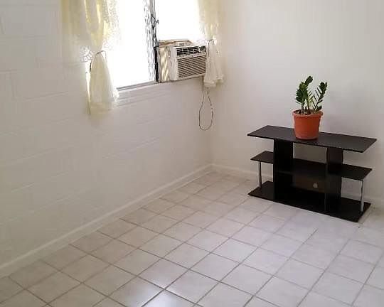 Bedroom with wall AC unit. Runs super nice and cold.