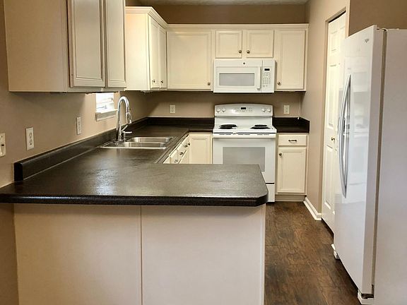 Spacious kitchen with plenty of cabinet space and storage. Kitchen window looks out to the backyard.