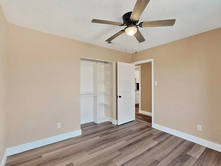 Unfurnished bedroom featuring light wood-style flooring, a ceiling fan, and a closet