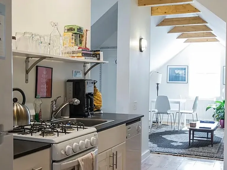 Full kitchen with small oven and range, fully stocked with plates, cookware, utensils, etc.
