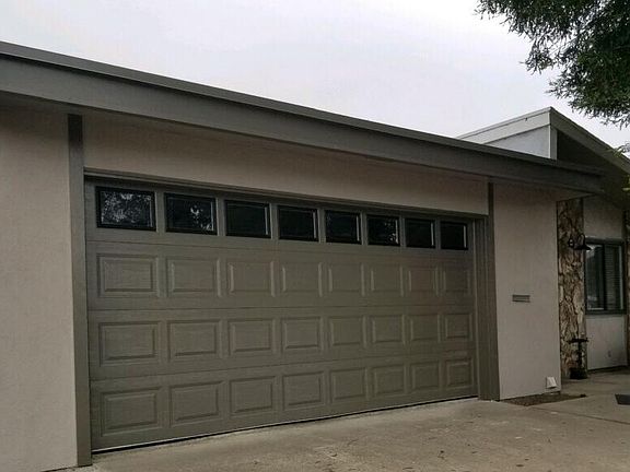 Two car garage, laundry area with dump sink and nice amount of storage cabinets.