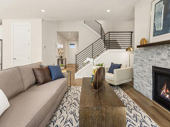 Beautiful gold cabinet hardware complements the quartz countertops and white tile backsplash