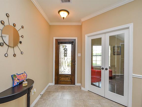 Adequately sized front entryway and to the left of the entrance is an enclosed study which is currently being used as an entertainment/bar area. The french doors are gorgeous!