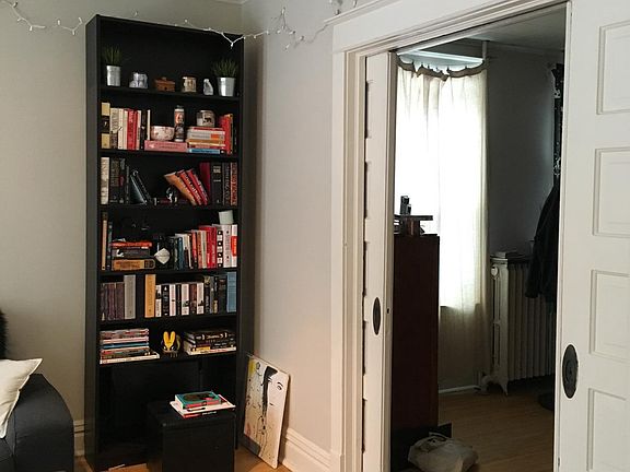 View from living room to bedroom (separated by pocket doors)