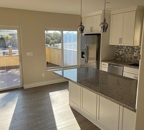 Large kitchen/great room with tons of window and sliding doors to expansive main level deck