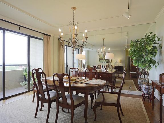 Dining room with custom drapes. Sliding door leads to balcony.