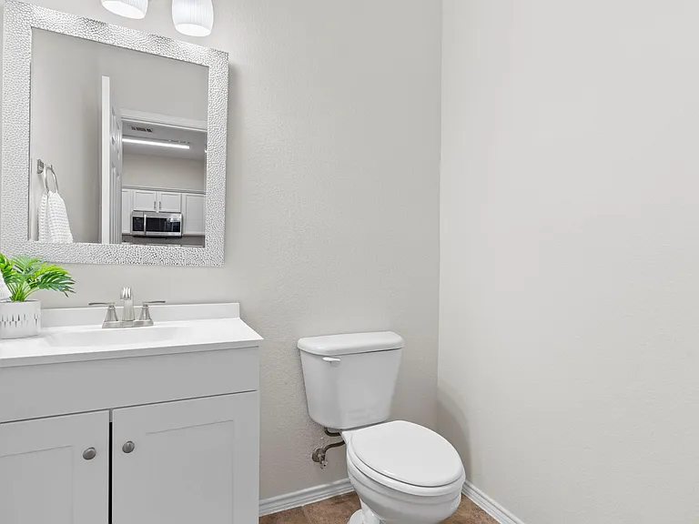 Downstairs half bath updated with new vanity, mirror and light fixture