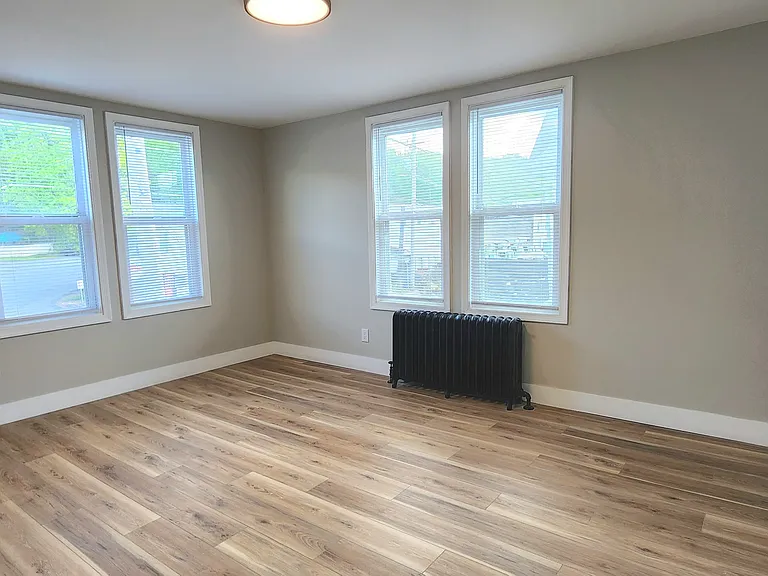 2nd floor bedroom located at rear of the home. Angle 1.
