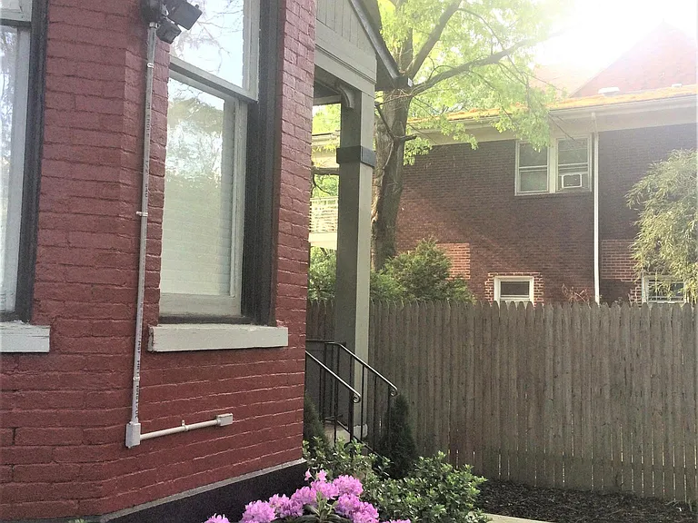 Exterior porch and yard is fenced for privacy.