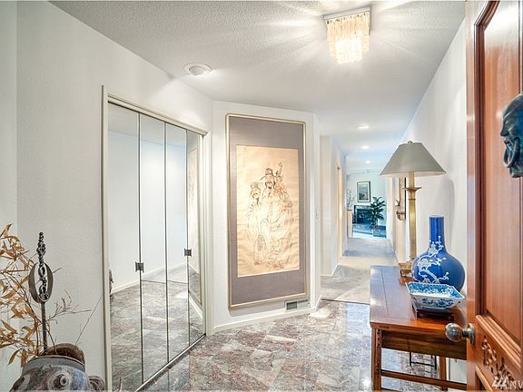 Spacious entry hall has beautiful marble tile.