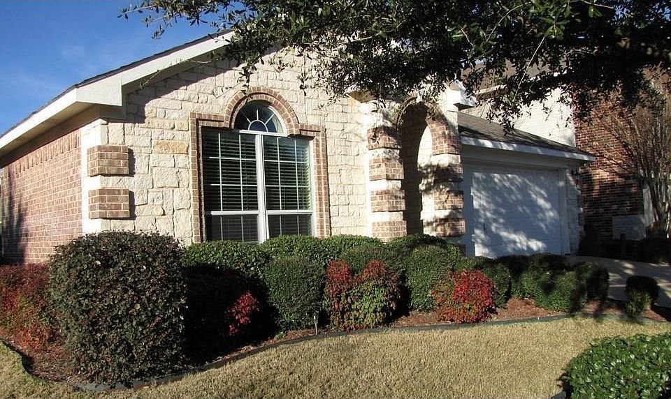 Beautiful stone front - brick ranch home with beautiful garden.