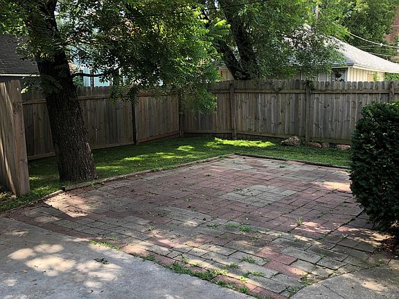 Very large, private backyard patio adjacent to parking and off the back door.