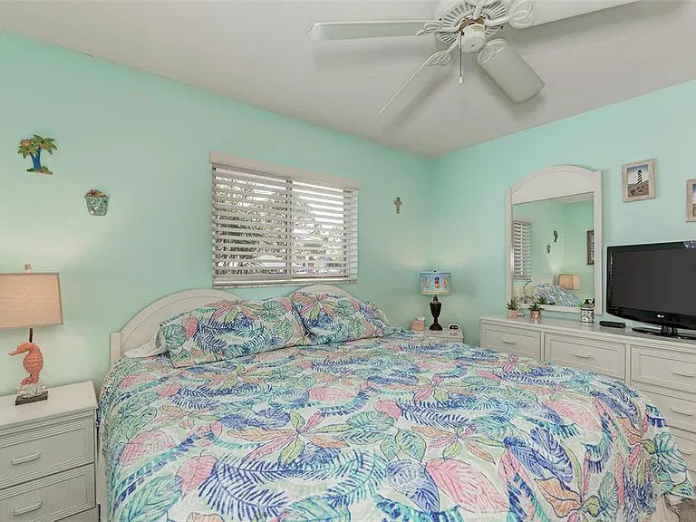 Our guest room is light, airy, and centered around this cozy queen bed. It's the perfect spot to catch a morning show on the TV or plan your day's adventures at the pool.