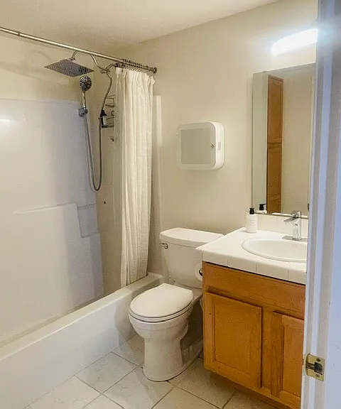 bathroom with updated shower head and storage
