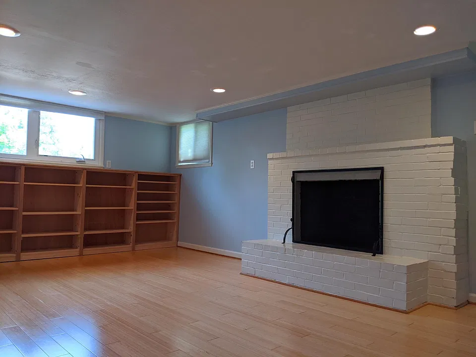 Primary bedroom with fireplace and built-in shelves