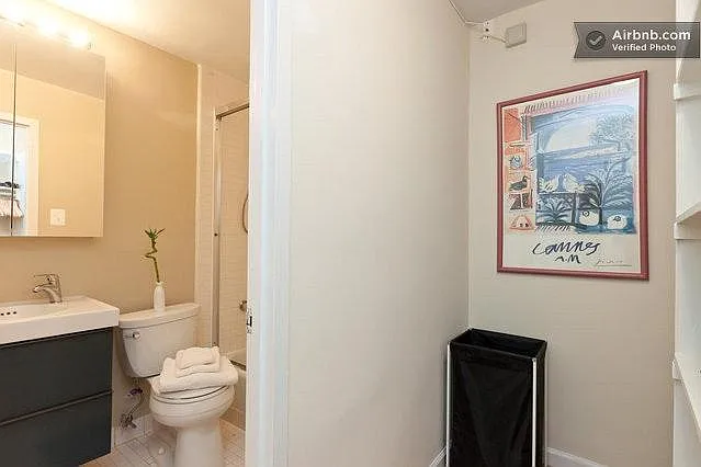 Walk-in closet leads to renovated bath