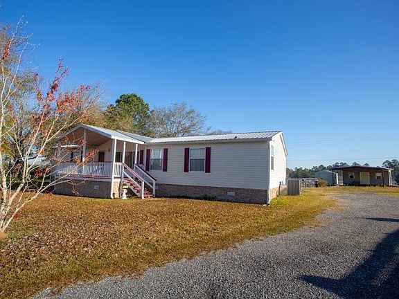 Gravel Driveway leads to 2 Car Carport