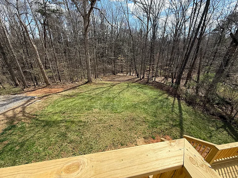 Spacious backyard adjourning undeveloped woods for peace and privacy