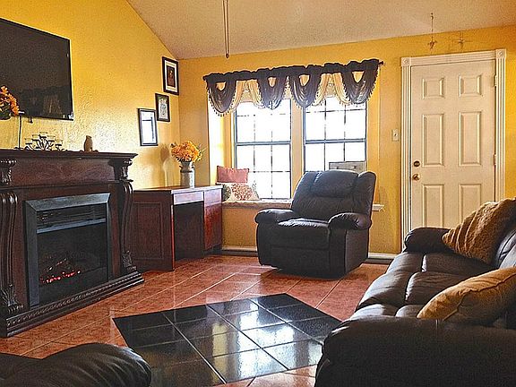 Large living area with high vaulted ceilings and bay window