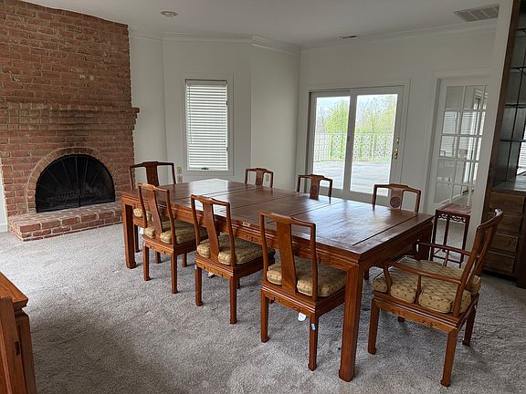 Dining room with fireplace and small beverage/bar (not shone)