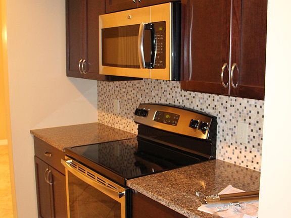Kitchen with granite countertops and stainless steel appliance package