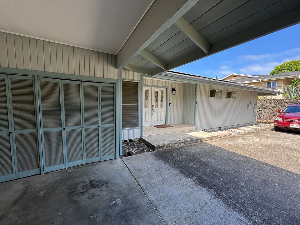 semi enclosed carport with washer/dryer hookups.