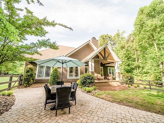 Home features craftsman style, natural stone columns, porches, and hardy-plank siding. Enjoy your own private oasis on 0.6 acres. Grill your favorite foods and entertain guests on the spacious stone-paver patio. Roast marshmallows over the built-in fir