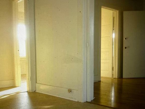 Bedroom access doors from dining area view (outdated, not current paint colors).