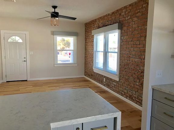 Gorgeous brick accent wall with wooden valences around the w