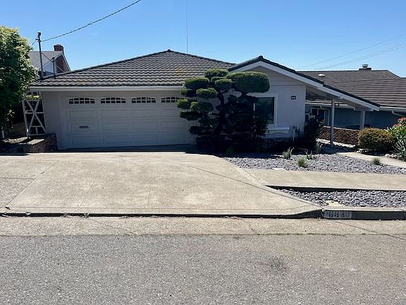Front of house showing 2 car garage.