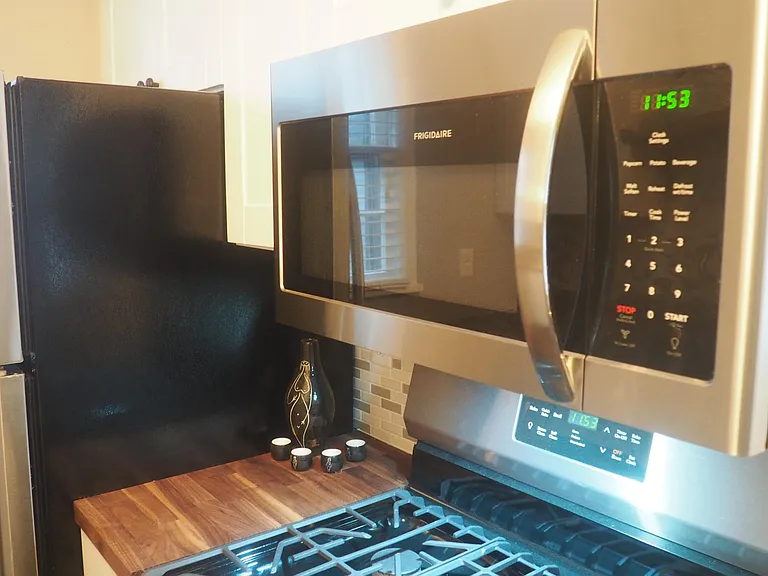 Frigidaire 5-burner gas stove, microwave and fridge