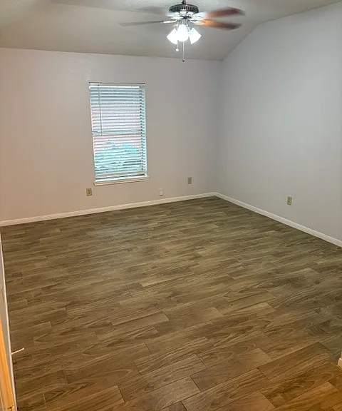 Spacious Living room with new tiled floors throughout the home and ceiling fans