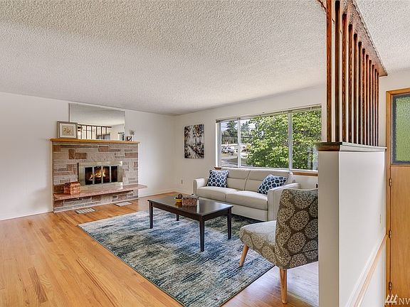 Gleaming hardwood floors can be enjoyed in the living room, hall and three upstairs bedrooms. This space is warmed by a wood burning fireplace. 