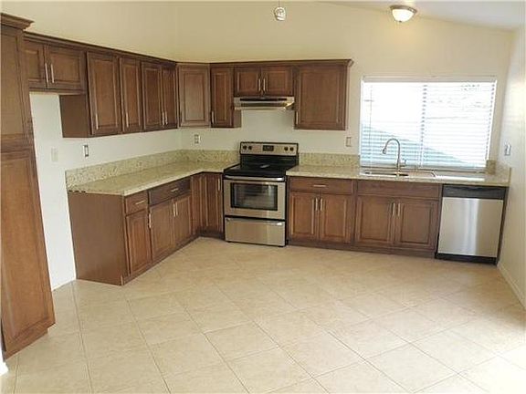 open concept kitchen, stainless appliances granite counters in kitchen and baths