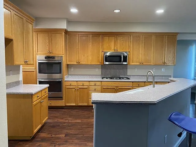 Large kitchen with stainless steel appliance. Open concept design to the family room