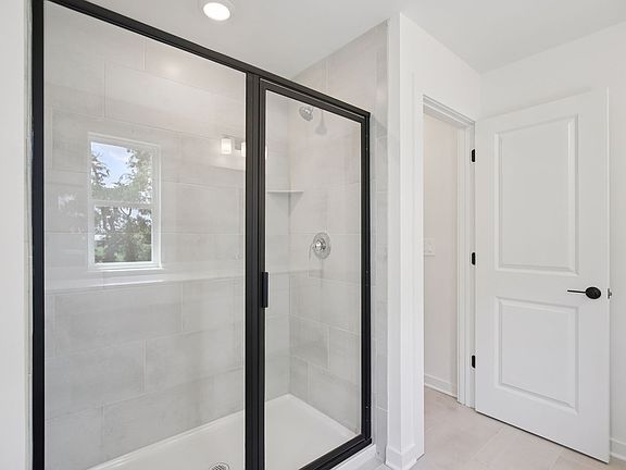 The primary bathroom offers dual vanity sinks and a walk-in shower.